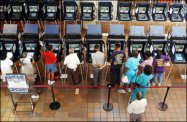 Residents of Dade County work electronic voting machines at a local voting station in Miami 18 October 2004. Authorities in Florida were looking for 58,000 absentee ballots whose disappearance stirred renewed controversy in the state that held up the 2000 presidential election for five weeks. [AFP/file]