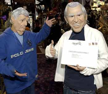 Wearing masks of the two presidential candidates, Mike Yoon (L), looking like Democratic presidential candidate John Kerry; and Daniel Cheatham, looking like Republican opponent U.S. President George W. Bush (R), check out costumes at the Abracadabra Superstore in New York, October 27, 2004, just a few days before Halloween. Cheatham holds his absentee ballot to mail today, sending it home to West Palm Beach, Florida. Bush masks have outsold Kerry masks by about 25% with Martha Stewart and Donald Trump costumes being the hottest sellers. [Reuters]