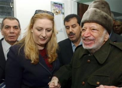 Palestinian leader Yasser Arafat and his wife Suha hold hands prior to Arafat's departure from his compound in the West Bank town of Ramallah in this picture released by the Palestinian Authority Friday Oct. 29, 2004. [AP]