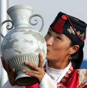 South Korea's Grace Park kisses a trophy after she won the CJ Nine Bridges