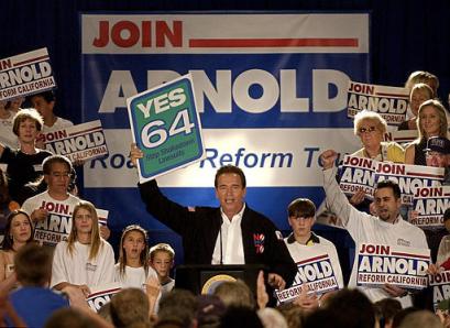 California Gov. Arnold Schwarzenegger holds up a sign supporting California Proposition 64 during a rally at the Del Mar Fairgrounds in Del Mar, Calif., Saturday, Oct. 30, 2004. Schwarzenegger kicked off his statewide Road to Reform Bus Tour in San Diego county to lend his support to a host of state propositions. [AP]