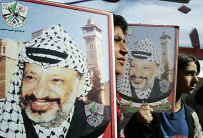Palestinian leader Yasser Arafat's health has suffered a setback and doctors treating him in France are carrying out more tests to discover why, Palestinian envoy Leila Shahid told Reuters November 3, 2004. Palestinians hold posters of President Yasser Arafat during a rally to support him in the West Bank city of Hebron, November 2, 2004. [Reuters] 