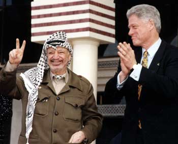 Palestinian leader Yasser Arafat, who rose from guerrilla icon to Nobel prize-winning peacemaker only to fall into isolation amid new violence with Israel, was declared dead in a Paris hospital November 10, 2004, officials said. The 75-year-old Palestinian president's death, announced at his West Bank headquarters of Ramallah, ended days of rumors over his condition. A December 14, 1998 file picture handed out by the Palestinian Authority shows Arafat (L) and former U.S President Bill Clinton during a visit in Gaza. [Reuters]