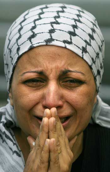 A Palestinian woman cries in Gaza, November 11,2004, after the announcement of the death of President Yasser Arafat. Palestinians announced a 40-day mourning period for President Yasser Arafat after he was declared dead in a French hospital on Thursday. [Reuters]