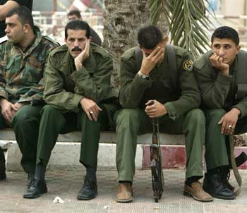 Palestinian security guards react in Gaza, November 11, 2004, after the death of the late President Yasser Arafat. [Reuters]