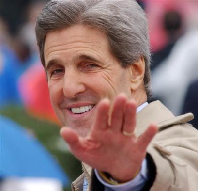 Sen. John Kerry, D-Mass., acknowleges the crowd as he walks to his seat at the William J. Clinton Presidential Center during opening ceremonies in Little Rock, Ark., Thursday, Nov. 18, 2004. The $165 million glass-and-steel center will be the home to Clinton's library collection of more than 80 million presidential items. [AP]