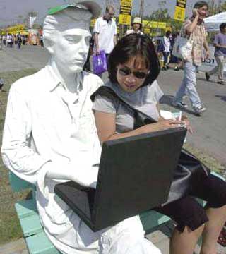 Teenagers and young men should keep their laptop computers off their laps because they could damage fertility, an expert says. File photo shows a life-like sculpture of a man using a mock laptop at a trade fair.