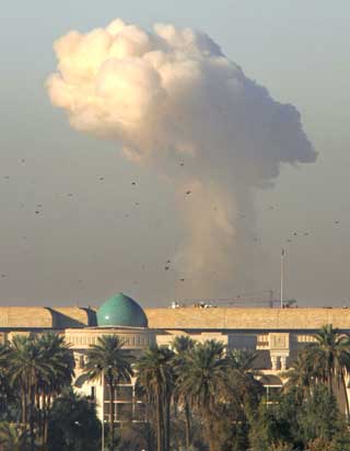A column of smoke rises after a powerful car bomb exploded at a checkpoint leading into the so-called "Green Zone" in Baghdad December 13, 2004. The building in the foreground comprises part of the U.S. Embassy in Baghdad, which was not directly affected by the blast. There were no immediate reports on injuries or deaths. [Reutrs]