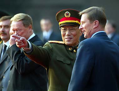 Vice-Chairman of the Central Military Commission and Defence Minister Cao Gangchuan (second right) speaks with visiting Russian Defence Minister Sergei Ivanov during a welcoming ceremony in Beijing yesterday. Ivanov announced China and Russia will jointly hold a first-ever military exercise next year. [newsphoto]