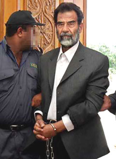Saddam Hussein met with a lawyer on December 16, 2004 for the first time since he was arrested a year ago, his defense team said. Saddam's defense lawyers said earlier this week they did not recognize the Iraqi interim government's plans to try the 67-year-old or his aides since they had been denied access to their clients and had not been given legal documents on which to prepare their case. Saddam is shown at a tribunal hearing July 1. [Reuters]