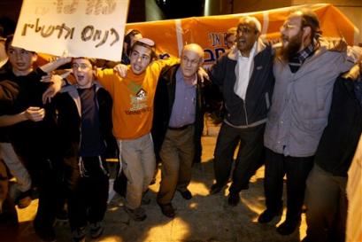 Supporters of the Israeli settler movement join arms as they sing following a news conference in Jerusalem, Monday, Dec. 20, 2004. Israeli settler leaders on Monday backed a call to resist the planned evacuation of settlements in the Gaza Strip and parts of the West Bank, even if it means going to jail, but said they remain opposed to using violence. [AP]