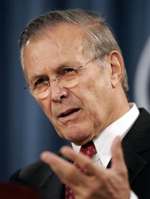 US Defense Secretary Donald Rumsfeld gestures during a news conference on Wednesday, Dec. 22, 2004 in Washington. Defense Secretary Donald H. Rumsfeld visited wounded soldiers and brought holiday greetings on Christmas Eve, Friday, Dec. 24, 2004 at an air base in Mosul where a suicide bomber killed 14 U.S. troops and eight other people earlier this week. [AP]