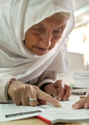 An elderly Palestinian woman looks for her name in a voter list during municipal elections in the West Bank town of Jericho, Thursday Dec. 23, 2004. Thousands of Palestinians crammed polling stations in scattered West Bank towns to vote in municipal elections Thursday that were a warm up for next month's presidential ballot and the first time the ruling Fatah movement and the Islamic militant group Hamas competed for voter support. [AP]
