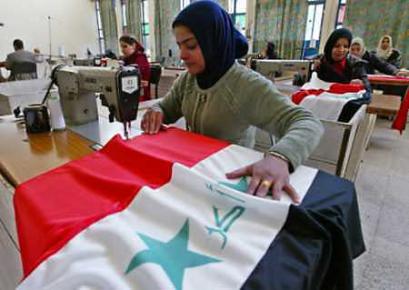 Workers make flags at an Iraqi government center for hearing and speaking impaired people in Baghdad December 21, 2004. The men and women at the center are sewing the flags as a contribution to the upcoming national elections on January 30, 2005. (Faleh Kheiber/Reuters) 