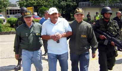 Photo provided by the U.S. Immigration and Customs Enforcement (ICE) showing the arrest of Dagoberto Florez, center, a reputed cocaine cartel leader wanted in the U.S. on drug-related charges, Tuesday, Dec. 28, 2004 in Medellin, Colombia. [AP]