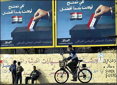 A boy rides his bicycle past billboards advertising elections. Plans have been unveiled to deploy 100,000 Iraqi police and soldiers to stave off a possible bloodbath on election day, as US President George W. Bush said polls would go on as scheduled on January 30. [AFP]
