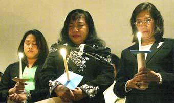 Members of Chicago's Indonesian community participate in a candlelight vigil, to mourn the loss of life and pray for the survivors of the earthquake that hit Southern Asia last week, at the Indonesian Consul General's residence in the Chicago suburb of Winnetka, December 31, 2004. Over 120,000 people perished in the disaster.