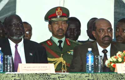 Sudanese President Omar al Bashir (R) sits next to rebel Sudan People's Liberation Movement John Garang (L) during the singing ceremony of two protocols in Naivasha, 90 km (55 miles) west of Nairobi December 31, 2004. Amid singing and whoops of joy, Sudan's government and southern rebels signed the final chapters of a peace deal Friday, paving the way for a comprehensive accord ending Africa's longest-running civil war. [Reuters]
