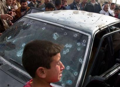 An Iraqi boy reacts after seeing his sister and both of his parents killed in the car, in Ramadi, 100 kilometers (60 miles) west of Baghdad, Wednesday, Jan. 5, 2005. Four Iraqi civilians were killed and two others were injured when U.S. soldiers opened fire after their convoy was attacked by rocket-propelled grenades in central Ramadi. The U.S. military had no immediate information about the incident. [AP]