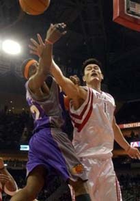 Phoenix Suns center Amare Stoudamire (32) and Houston Rockets center Yao Ming (11), of China, battle for the rebound in the first half Wednesday, Jan. 5, 2005, in Houston. [AP]