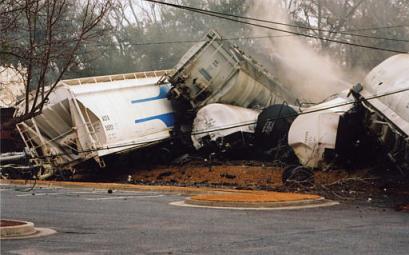 Chemicals leak from the tanks of a derailed train in Graniteville, S.C. Thursday Jan. 6, 2005. A Norfolk Southern freight train carrying chlorine gas struck a parked train early Thursday, killing two people and injuring at least 180 others, authorities said. Most of the injured were treated for respiratory ailments and released, authorities said. At least 46 people remained in the hospital, including 13 who were in critical condition. (AP Photo/Nina J. Nidiffer) 