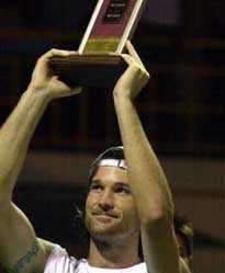 Spain's Carlos Moya holds the trophy after winning the ATP Chennai Open in Madras, India, Sunday, Jan. 9, 2005. [AP]