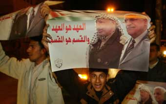 Palestinians celebrate in Gaza January 9, 2005 after Mahmoud Abbas won a landslide victory in elections to succeed Yasser Arafat. Abbas secured a strong mandate to talk peace with Israel after years of bloodshed and end corruption at home.