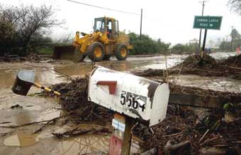 A bulldozer moves mud and debris off of Ventura Avenue after heavy rainfall fell in the area Monday, Jan. 10, 2005, in Ventura, Calif. [AP]