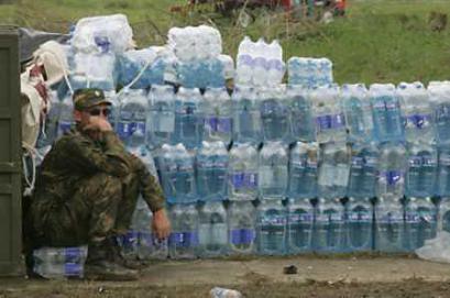 A Russian soldier rests in front of aid supplies at the airport in the tsunami-hit city of Banda Aceh on January 13, 2005. New security restrictions on tsunami relief in Indonesia were aimed only at ensuring the safety of foreigners, a government minister said on Thursday, aiming to allay fears that emergency operations could suffer. (Supri/Reuters) 