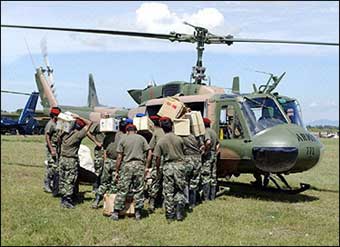 This picture released by Pakistan's Inter-Service Public Relations (ISPR), shows Pakistani army doctors and paramedics loading medicines and other equipment onto a helicopter to be transported to the tsunami victims at Lamna, a small town, some 80 kms north of Banda Aceh.(AFP