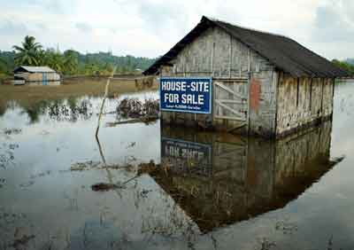 Damaged houses are seen submerged in water after they were hit by last month's tsunami in Port Blair, the capital of India's Andaman and Nicobar archipelago January 13, 2005. [Reuters]