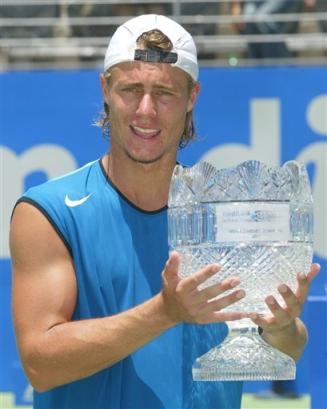 Australia's Lleyton Hewitt (news) holds the first place trophy after winning the finals of the Sydney International tennis tournament against Ivo Minar of the Czech Republic in Sydney, Australia, Saturday, Jan. 15, 2005. Hewitt won the match in straight sets, 7-5, 6-0, giving him his fourth Sydney International title. (AP Photo/Dan Peled) 
