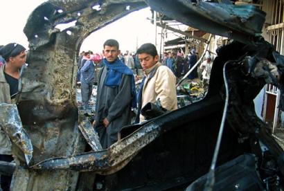 Iraqis gather outside the Shiite mosque in Khan Bani Saad, near Baqouba, some 35 kilometers (20miles) northeast of Baghdad, late Thursday, Jan. 13, 2005. A car bomb detonated after prayers Thursday killing four and injuring 13. (AP Photo/Mohammed Adnan) 