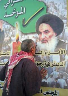 An Iraqi man kisses an electoral poster featuring the Shiite cleric Ayatollah Ali al Sistani, in Najaf, some 160 kilometers (100 miles) south of Baghdad, Saturday, Jan. 15, 2005. Sunni Muslim militants claimed responsibility Friday for the assassination of a community leader promoting the election on behalf of al-Sistani. (AP 