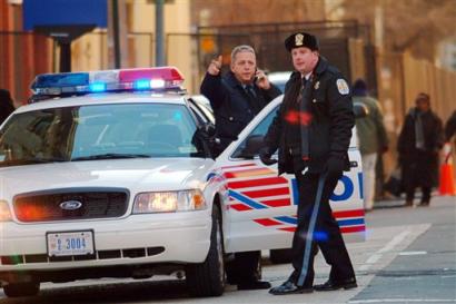 Police stand near the White House Tuesday, Jan. 18, 2004 watching as a distraught man threatens to blow up his van. The standoff, apparently instigated by a domestic dispute, snarled rush-hour traffic in downtown Washington. [AP]