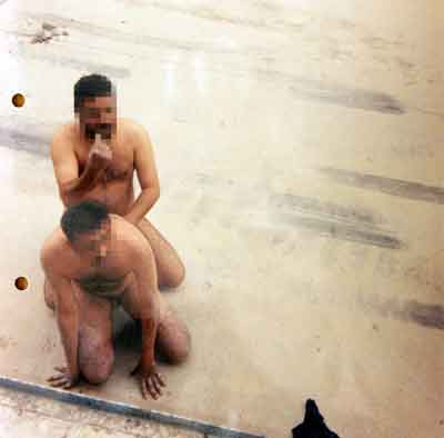 An undated handout photograph, issued on January 18, 2005, that is to be used as evidence in a court martial in Osnabrueck, Germany, purports to show Iraqi detainees simulating sexual acts. Three British soldiers pleaded not guilty at a court martial on Tuesday to abusing and sexually humiliating Iraqi civilians in May 2003, although one admitted he had beaten a detained man. Lance corporals Darren Larkin and Mark Cooley and Corporal Daniel Kenyon, all from the Royal Regiment of Fusiliers, face charges of mistreating Iraqis during an operation to stop looting in the chaotic weeks after the invasion of Iraq. [Reuters]