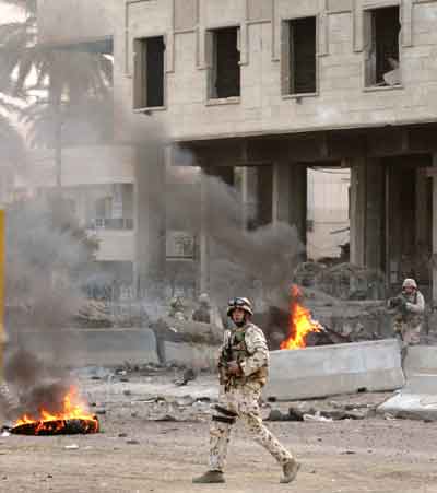 An Australian soldier secures the area near the Australian embassy after a suicide car bomb attack in Baghdad early January 19, 2005. [Reuters]