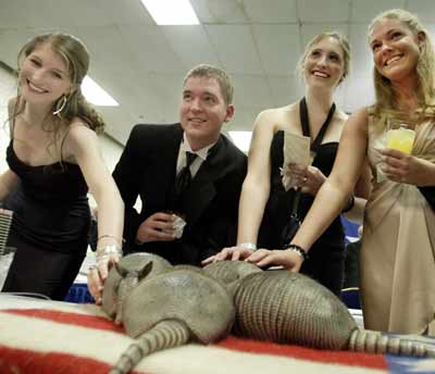 Guests pose for a photograph with armadillos at the Black Tie and Boots Inaugural Ball in Washington, D.C., January 19, 2005. The event is part of celebrations leading up to the inauguration of President Bush for his second term January 20. [Reuters]