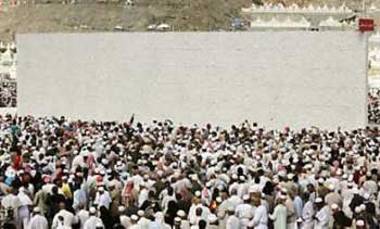Muslim pilgrims 'stone the devil' in Mena outside Mecca, January 21, 2005. About two million Muslims from all over the world gathered in Mena to perform the casting of seven stones at pillars symbolizing Satan. Haj is one of a Muslim's duties, as described in the five pillars of Islam. 