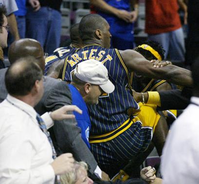 Indiana Pacers forward Ron Artest goes into the stands during an altercation with fans Friday, Nov. 19, 2004, in Auburn Hills, Mich. Behind Artest, wearing a white hat, is John Green, of West Bloomfield Township, Mich. Green identified himself as the man behind Artest during a television interview. Pacers coach Rick Carlisle says the Detroit Pistons coaches and security lapses at The Palace of Auburn Hills bore responsibility for the brawl that broke out at a Nov. 19 game with the Detroit Pistons. [AP/file/