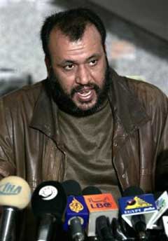 A spokesman for the local Al Aqsa Martyrs Brigades militant group in Gaza, who would only identify himself as Abu Ibrahim, talks to the media in Gaza city, Saturday Jan. 22, 2005. The man who represents a local group of Al Aqsa, not the entire faction, said Saturday it is ready for a cease-fire providing Israel halts military operations and begins releasing Palestinian prisoners. (AP 