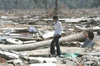 An Indonesian woman searches for possessions amongst the rubble of destroyed homes in the village of Lhoknga, on the outskirts of Banda Aceh, Indonesia Friday Jan. 21, 2005. Most of the village was wiped out by the Dec. 26 tsunami. (AP
