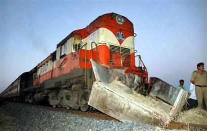 A policeman stands near the site of train accident at Kanhan, about 800 kilometers (490 miles) northeast of Bombay, India, Thursday, Feb. 3, 2005. A passenger train smashed into a trailer carrying wedding guests Thursday in western India, killing at least 52 people and injuring 10 others, a railway official and witnesses said. [AP]