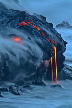 Lava from Kilauea volcano in Hawaii Volcanoes National Park enters the Pacific Ocean at dawn on Wednesday, Feb. 2, 2005, in Volcano, Hawaii. [AP]