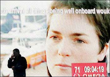 A man stands in front of a giant television monitor outside The National Maritime Museum in Falmouth which shows the face of Ellen Macarthur. MacArthur became the fastest ever sailor to complete a solo non-stop circumnavigation of the globe as she crossed the finish line at Ushant, off the French coast. [AFP]