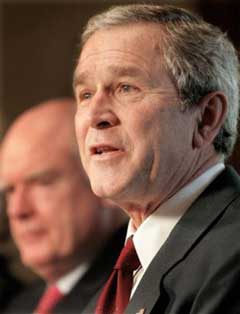 US President Bush speaks with reporters, Monday, Feb. 7, 2005, in the Cabinet Room of the White House. Bush sent Congress a $2.57 trillion spending plan Monday, constrained by war and record deficits, that seeks to slash spending in a number of popular programs from farm subsidies to health care. At left is Secretary of Treasury John Snow. [AP]