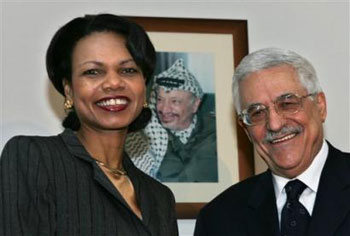 U.S. Secretary of State Condoleezza Rice, left, and her host Palestinian Authority (news - web sites) President Mahmoud Abbas, also known as Abu Mazen, stand next to a photo of the late Palestinian leader Yasser Arafat in the Presidential headquarters in the West Bank town of Ramallah Monday Feb. 7, 2005. Rice wound up two days of meetings with Israeli and Palestinian officials on her first visit to the region since taking office. [AP] 