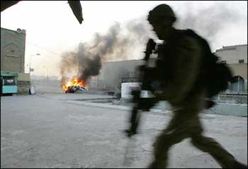 A US soldier runs for cover after insurgents opened fire on their convoy in January 31. The US military announced that one of its soldiers was shot dead north of Baghdad. [AFP/File]