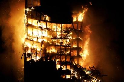 A 32-story office building is seen engulfed in fire shortly before the collapsing of the upper floors in Madrid, Spain, early Sunday, Feb. 13, 2005. The cause of the blaze was not immediately known. (AP Photo/Jasper Juinen) 