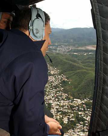 Venezuelan President Hugo Chavez flies over flood damaged areas in Miranda state near Caracas, February 12, 2005. Rescue workers struggled to reach remote villages in Venezuela's Andean mountains that were cut off by torrential rains and landslides that have killed at least 26 people in nearly a week. (Reuters) 